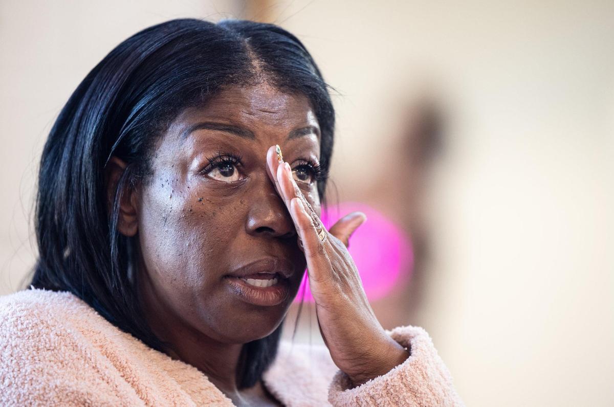 Robbie McNair-Guzman, owner of The Good Life at Enderly Park in Charlotte, wipes away a tear as she talks about racism during an interview on April 1, 2022. McNair has been clashing with management of Jim Noble’s businesses about a shared parking lot that all of the nearby businesses’ customers use.