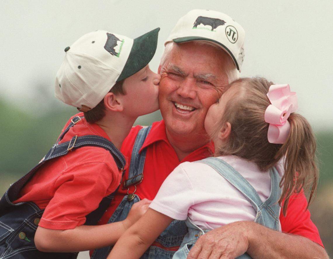 5/23/00 Former stock driver/moonshine runner Junior Johnson, who is going into the North Carolina Stock Car Hall of Fame, has left his colorful life behind and lives a quiet life with his wife and two young children. He gets a kiss from son, Robert, 6,left, and daughter, Meredith, 4. CHRISTOPHER A. RECORD/Staff