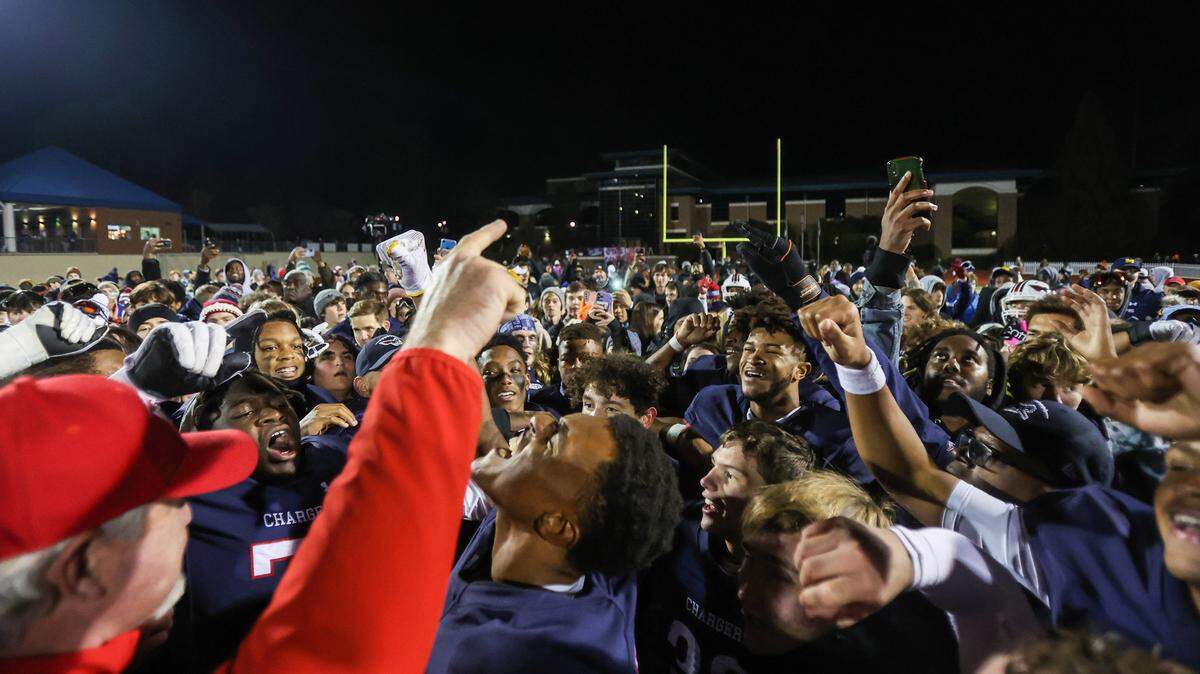 Providence Day students and players celebrate winning the NCISAA state high school football championship by defeating Charlotte Catholic, 55-13, on Friday, November 18, 2022.