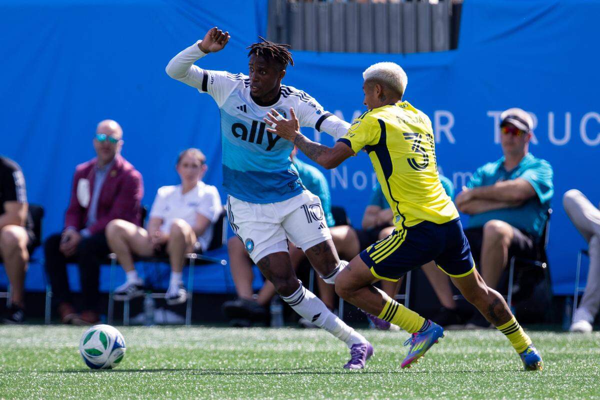 Apr 5, 2025; Charlotte, North Carolina, USA; Charlotte FC forward Wilfried Zaha (10) cuts by Nashville SC midfielder Andy Najar (31) during the second half at Bank of America Stadium. Mandatory Credit: Scott Kinser-Imagn Images