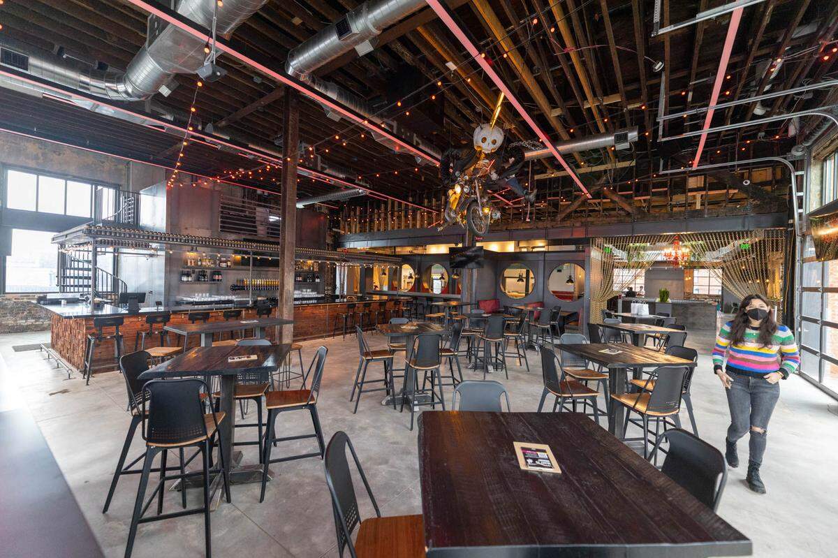 The indoor seating at Resident Culture in South End, where Cluck Design Collaborative was the architect, Liles Construction was the general contractor and artist Jeff Hamrick brought to life the skeletal biker on Resident Culture’s flagship IPA, Lightning Drops.