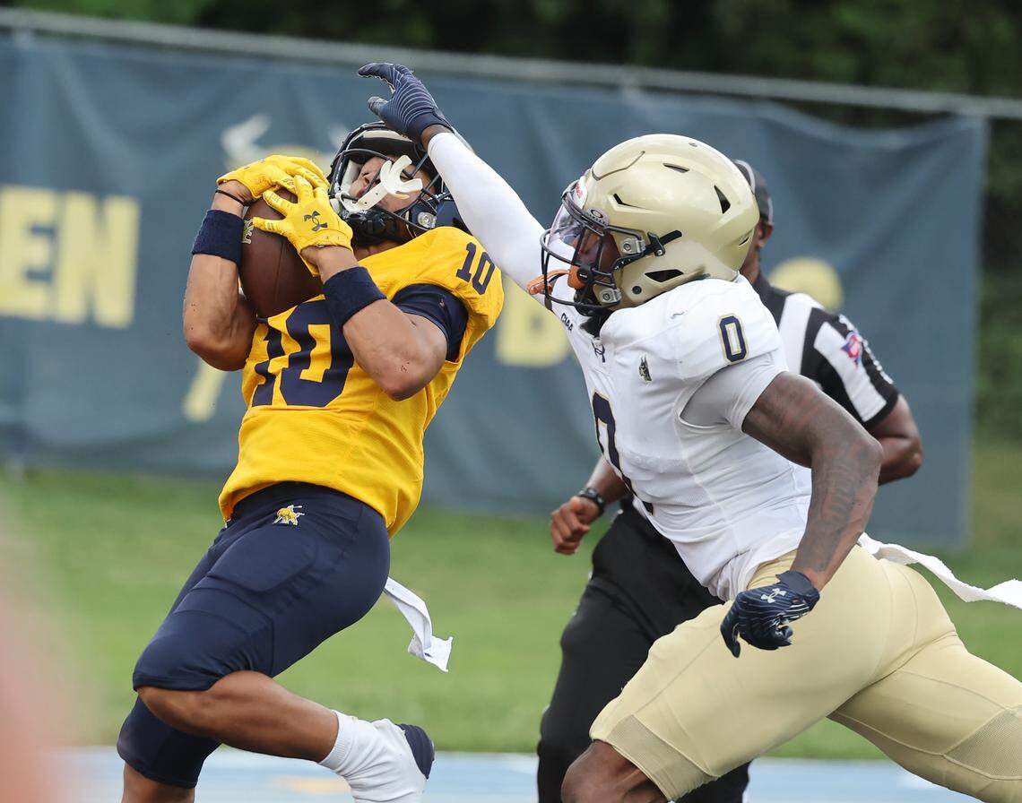 John C. Smith University's Isaiah Perry scores a touchdown in the third inning as Bluefield State University's Kamaree Wells tries to stop him Saturday, Sept. 27, 2025 in Charlotte