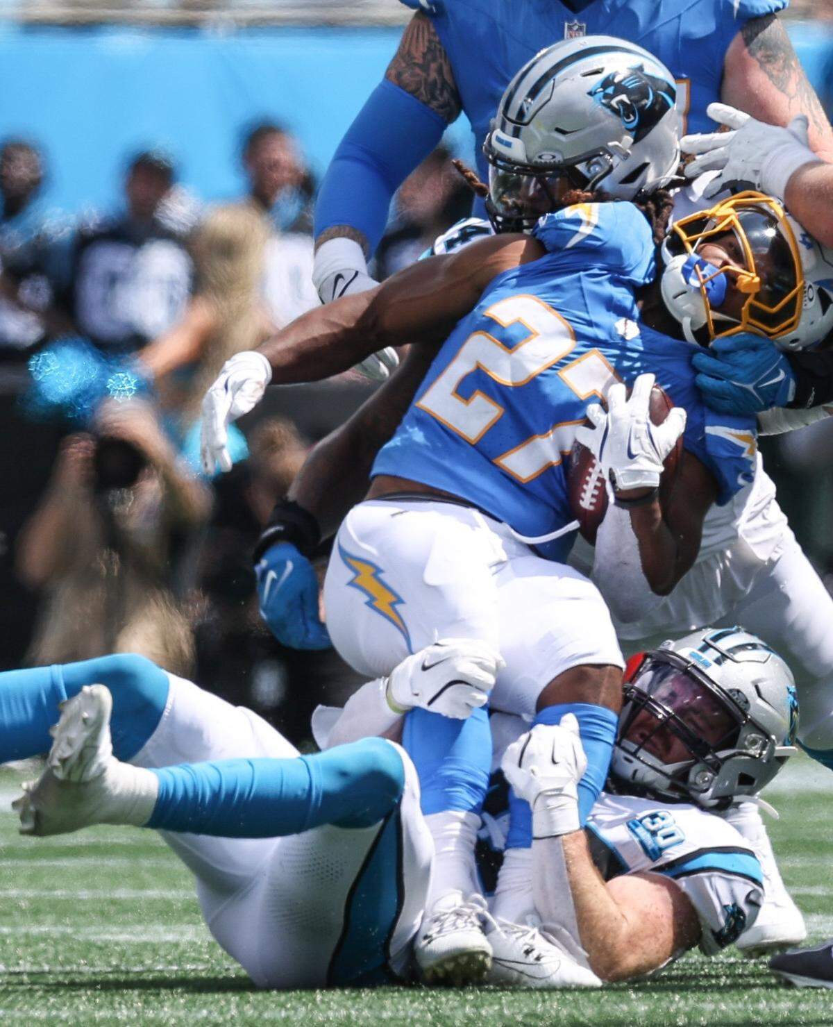 Chargers runningback J.K. Dobbins is pulled down by Panthers linebackers Shaq Thompson Josey Jewell and during the game at Bank of America Stadium in Charlotte, NC on Sunday, September 15, 2024.