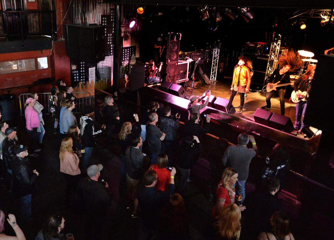 Crowds watch the Rock U Roadshow Band perform during the last show at the old Amos’ Southend in 2017.