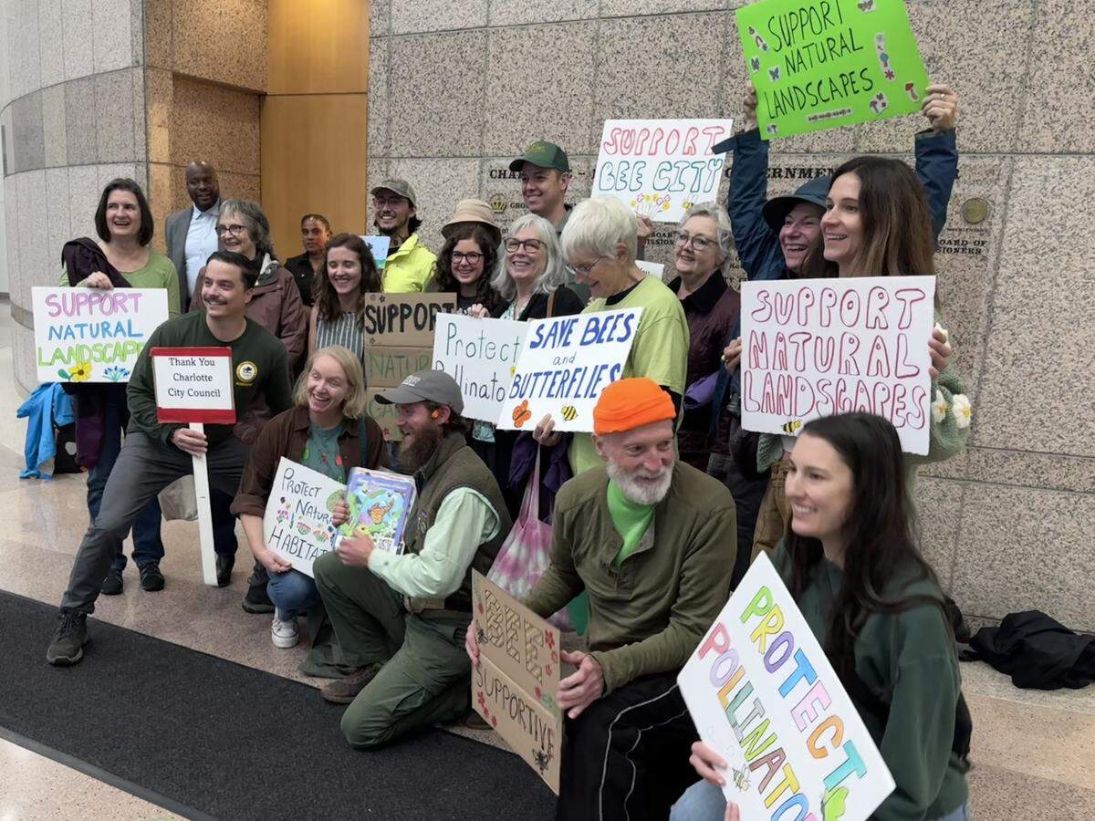 Members with the Coalition to Protect our Urban Nature in Charlotte pose outside the City Council chamber on Oct. 27, 2025, for a celebratory photo. Mayor Vi Lyles said the city would change its vegetation height ordinance to exempt naturalistic gardens.