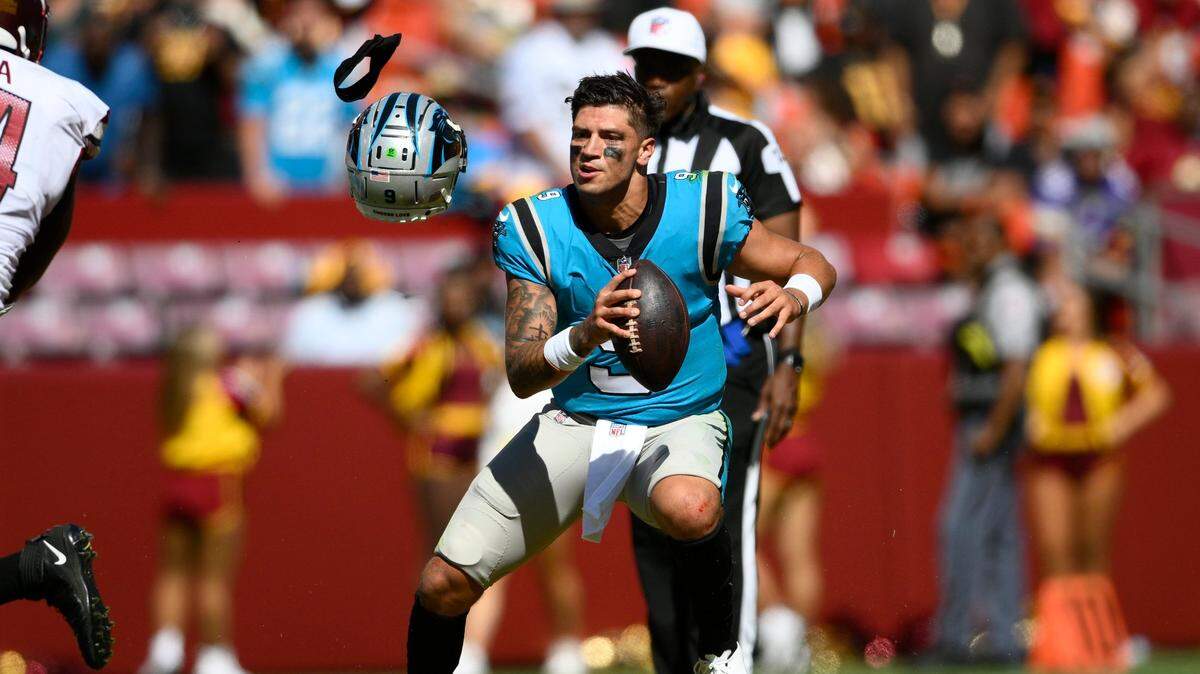 Carolina Panthers quarterback Matt Corral loses his helmet after it was pulled off by Washington Commanders defensive end Shaka Toney during the second half of a preseason NFL football game, Saturday, Aug. 13, 2022, in Landover, Md. The Panthers won, 23-21.