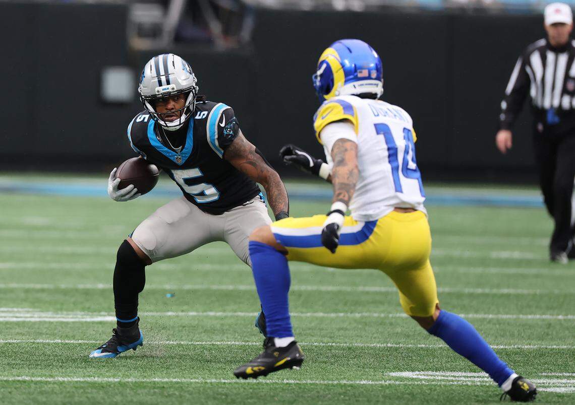 The Rams’ Cobie Durant tries to tackle Carolina Panthers running back Rico Dowdle on Nov. 30 in Charlotte.