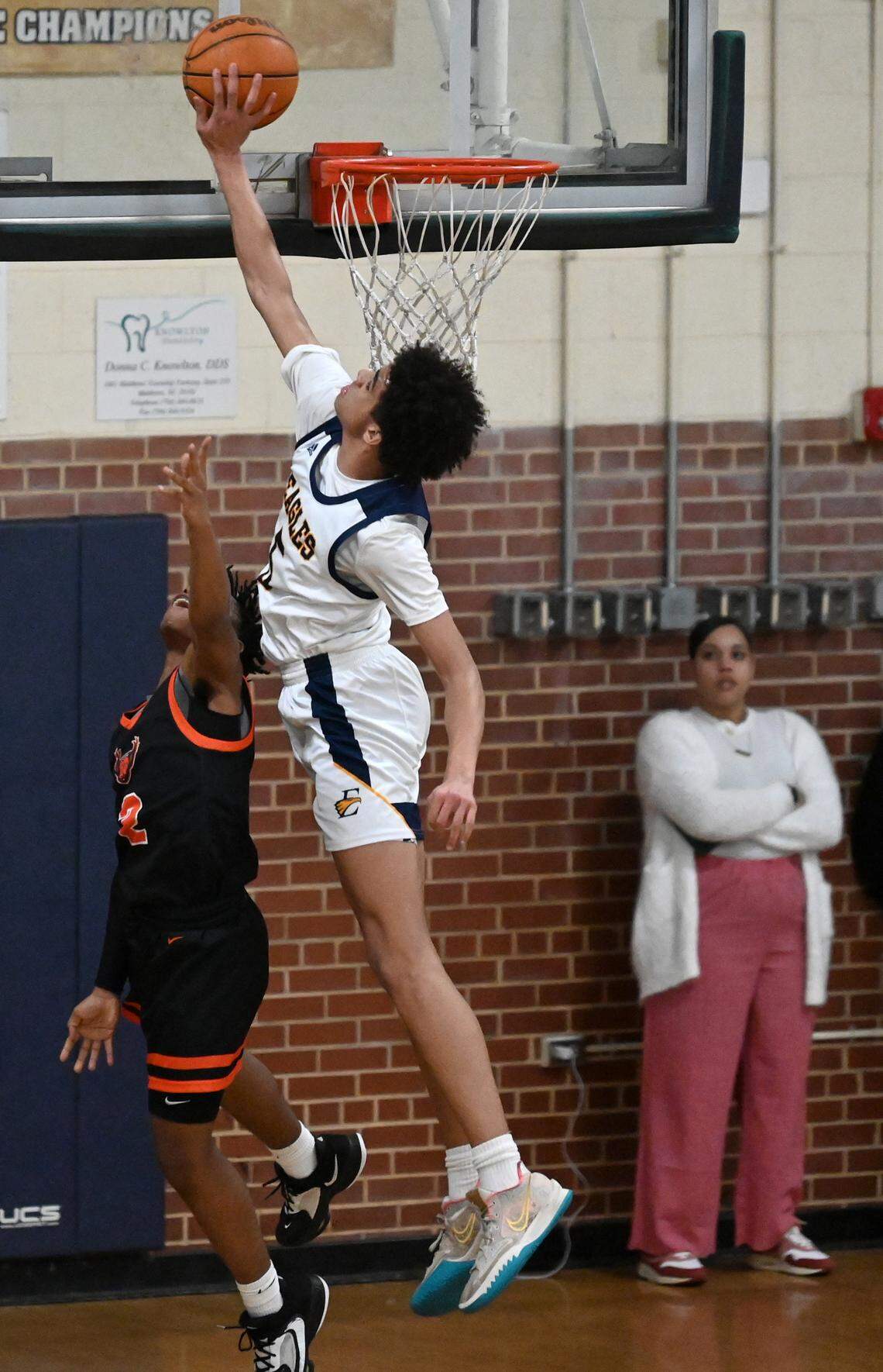 East Meck’s Jordan Buzzard, right, blocks a shot by Rocky River’s Kamal Brantley, left, during action on Friday, January 26, 2024 at East Meck High. Rocky River defeated East Meck 66-57.