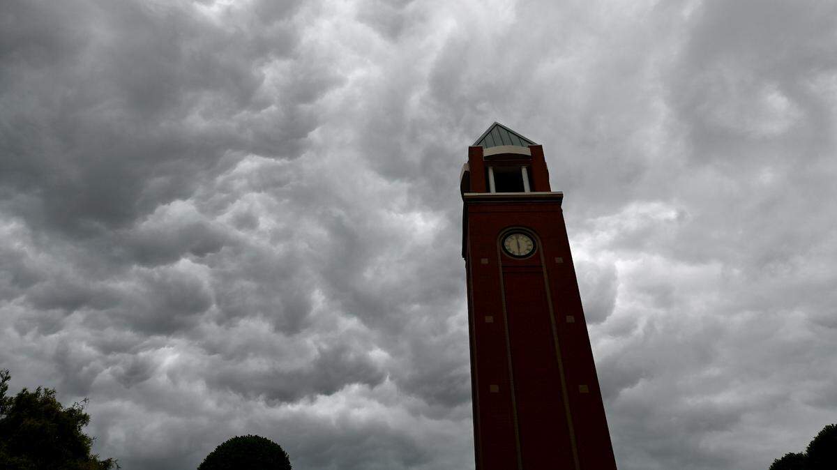 Storm clouds pass over the clock tower in the Village of Lake Park in Union County on Monday, August 7, 2023.