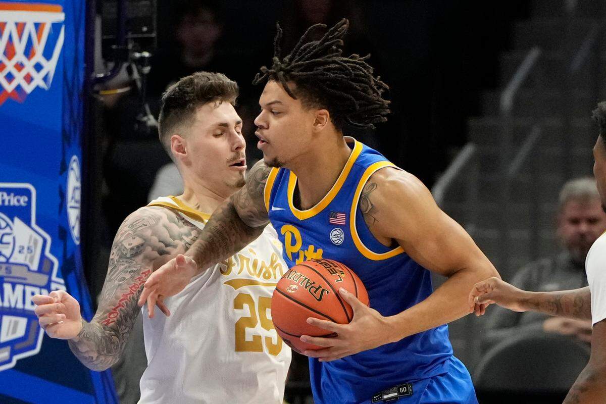 Mar 11, 2025; Charlotte, NC, USA; Pittsburgh Panthers forward Cameron Corhen (2) with the ball as Notre Dame Fighting Irish forward Nikita Konstantynovskyi (25) defends in the first half at Spectrum Center.