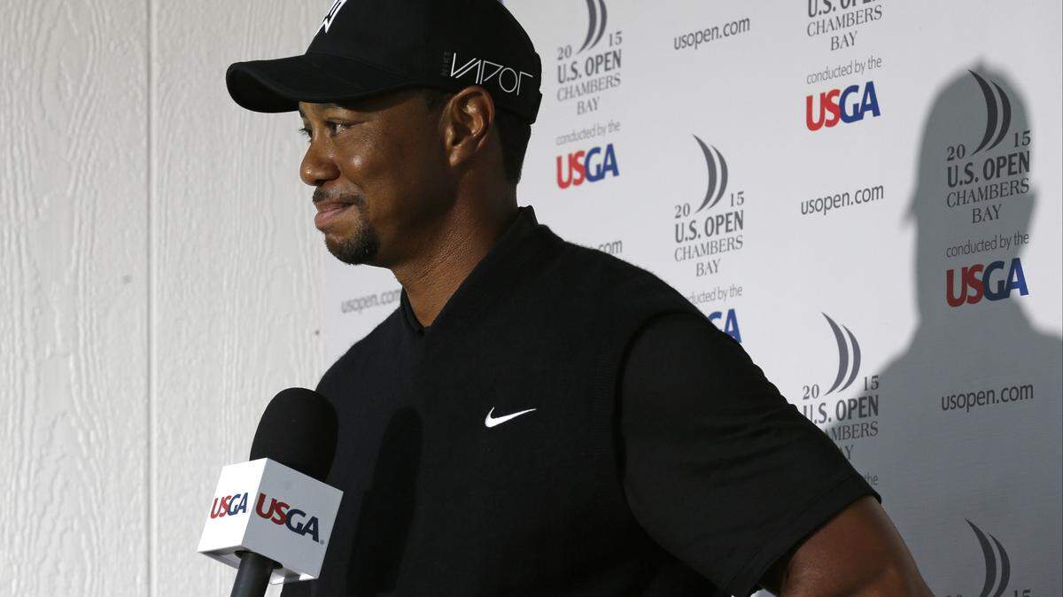 In this file photo, Tiger Woods speaks to the media during a news conference after shooting a 10 over-par 80 in the first round of the U.S. Open golf tournament at Chambers Bay in University Place, Wash. Woods has filed his entry to play in the U.S. Open for the first time since 2015. The USGA says Woods officially entered on Thursday, April 12, 2018, four days after he tied for 32nd in the Masters.