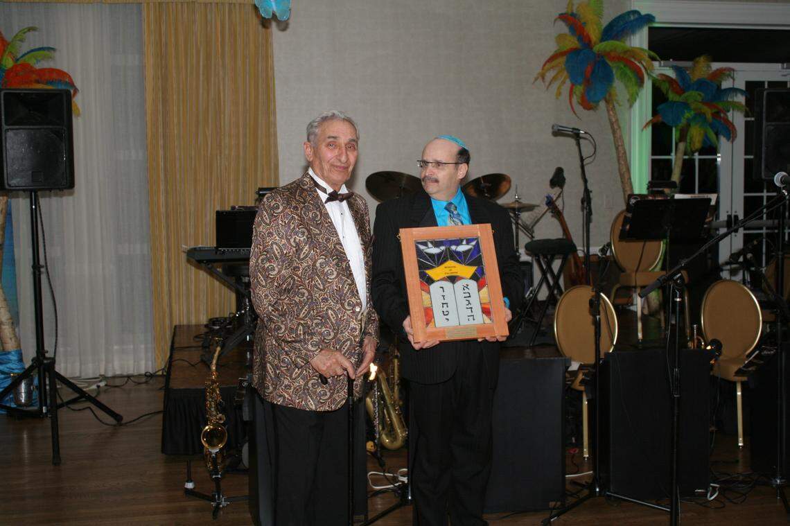 Alan Nash, right, presents former N.C. Sen. Marshall Rauch with the Wisdom of Solomon Lifetime Achievement Award in 2013.