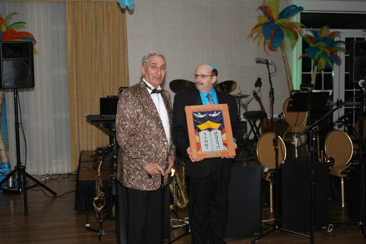 Alan Nash, right, presents former N.C. Sen. Marshall Rauch with the Wisdom of Solomon Lifetime Achievement Award in 2013.