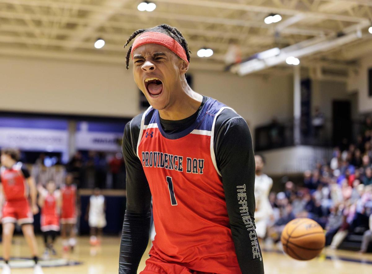 Providence Day’s Trajan Thompson (1) steals the ball in the backcourt and goes in for the dunk and celebrates. Carmel Christian would host Providence Day in the NCISAA state semifinal Tuesday February 18, 2025.