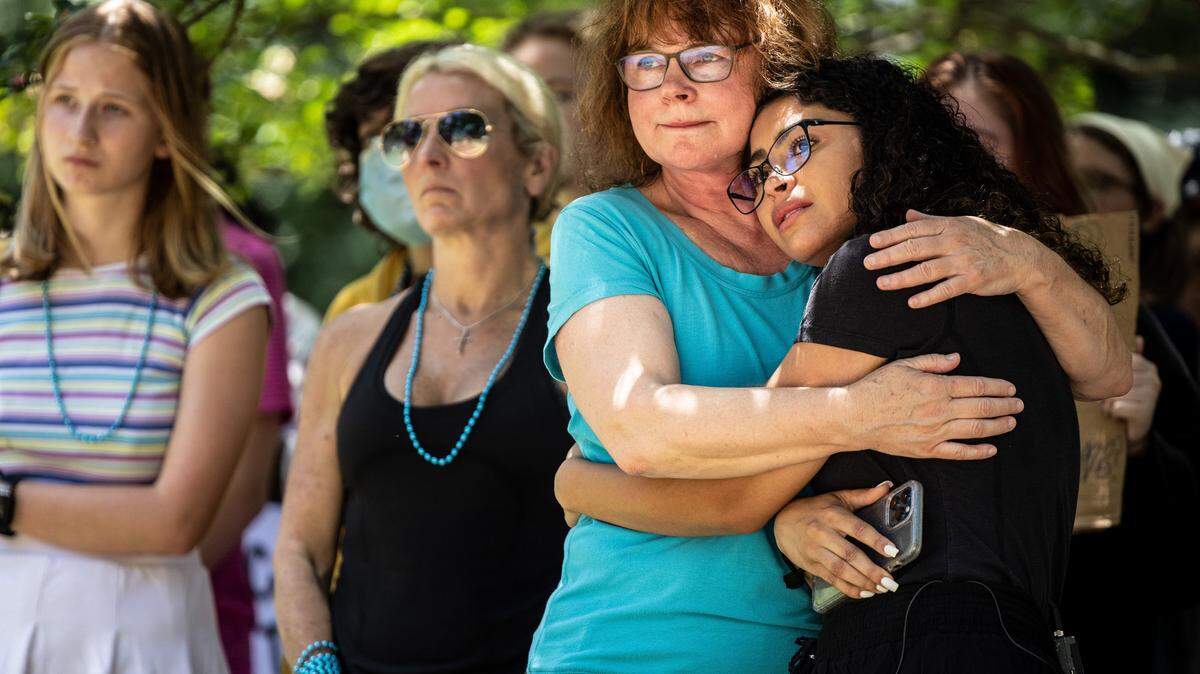 Kay Mayes holds her daughter, Serena Evans, after Serena spoke publicly about her sexual assault at Myers Park High School. Students organized a June 29, 2021 protest against Myers Park for the way the school has handled sexual assault allegations in recent years.