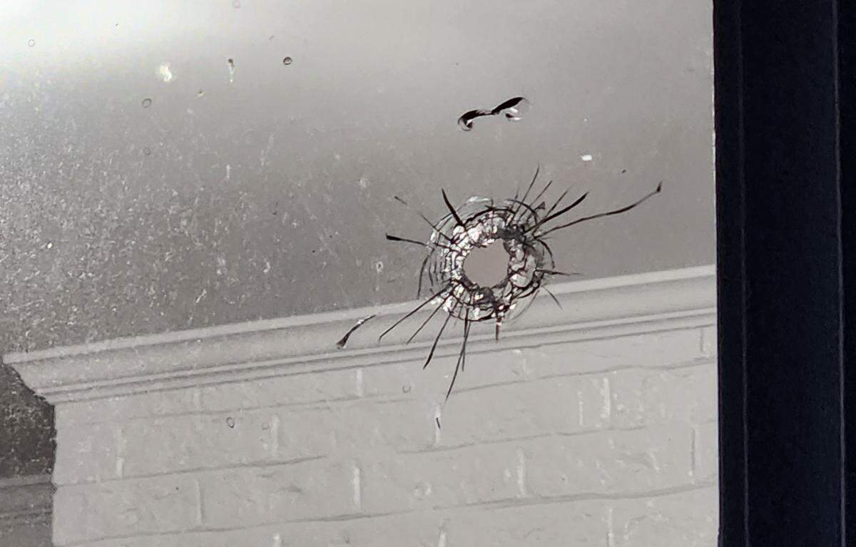 The bullet hit a window in the home’s laundry room, according to the police report.