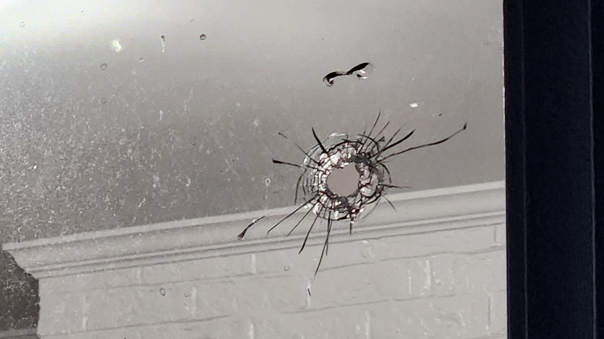 The bullet hit a window in the home’s laundry room, according to the police report.