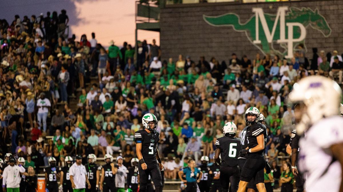 Myers Park quarterback Wendell Thompson surveys the field before he huddles the team against Ardrey Kell at Myers Park High in Charlotte on Friday, October 6, 2023.