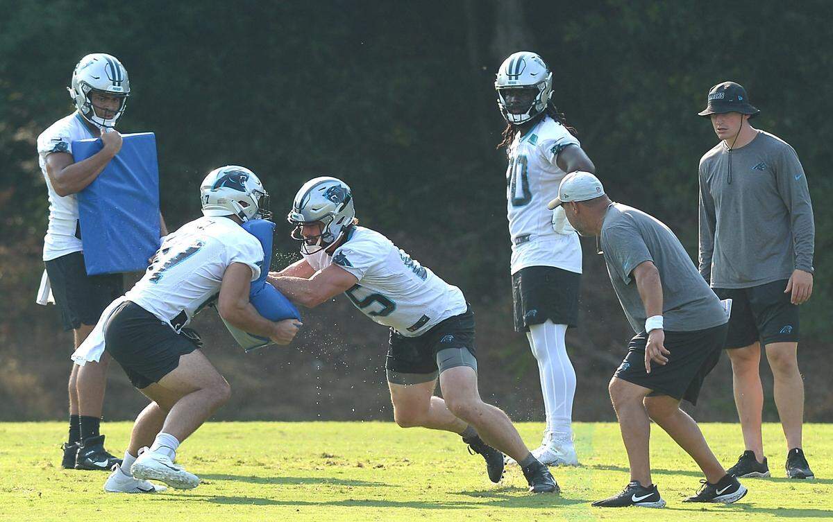 Carolina Panthers tight end Dan Arnold, center, battles teammate Giovanni Ricci, left, during a drill on Thursday, July 29, 2021 at Wofford College in Spartanburg, SC.