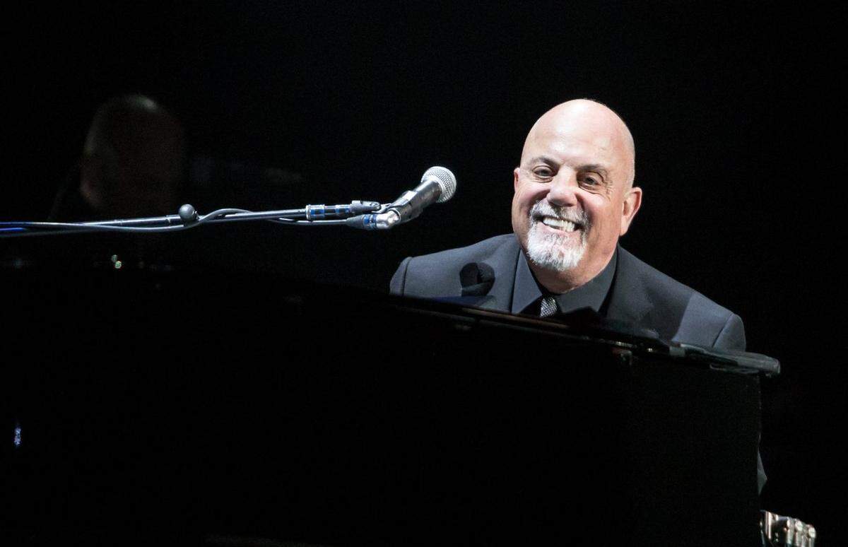 Billy Joel smiles at the crowd while performing at the Time Warner Cable Arena in Charlotte, NC on Saturday, December 5, 2015.