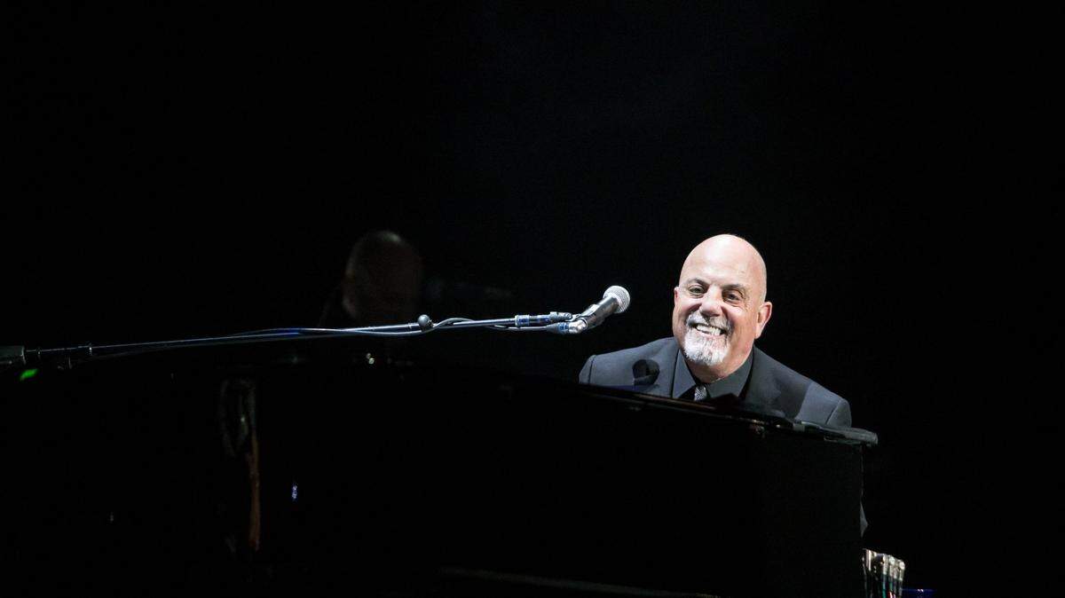 Billy Joel smiles at the crowd while performing at the Time Warner Cable Arena in Charlotte, NC on Saturday, December 5, 2015.