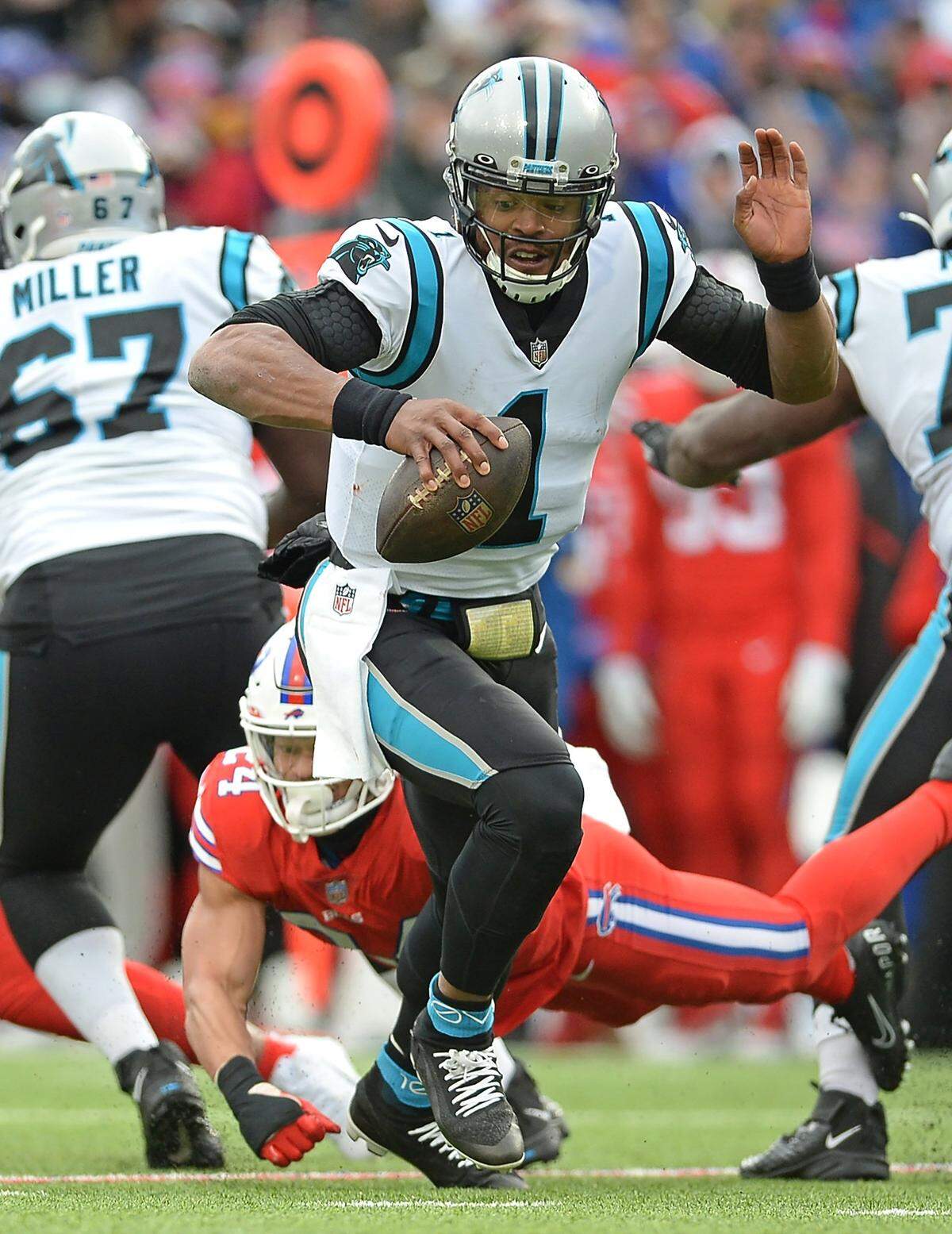 Carolina Panthers quarterback Cam Newton scrambles as the Buffalo Bills defenses apply pressure during second quarter action at Highmark Stadium in Orchard Park, NY on Sunday, December 19, 2021.