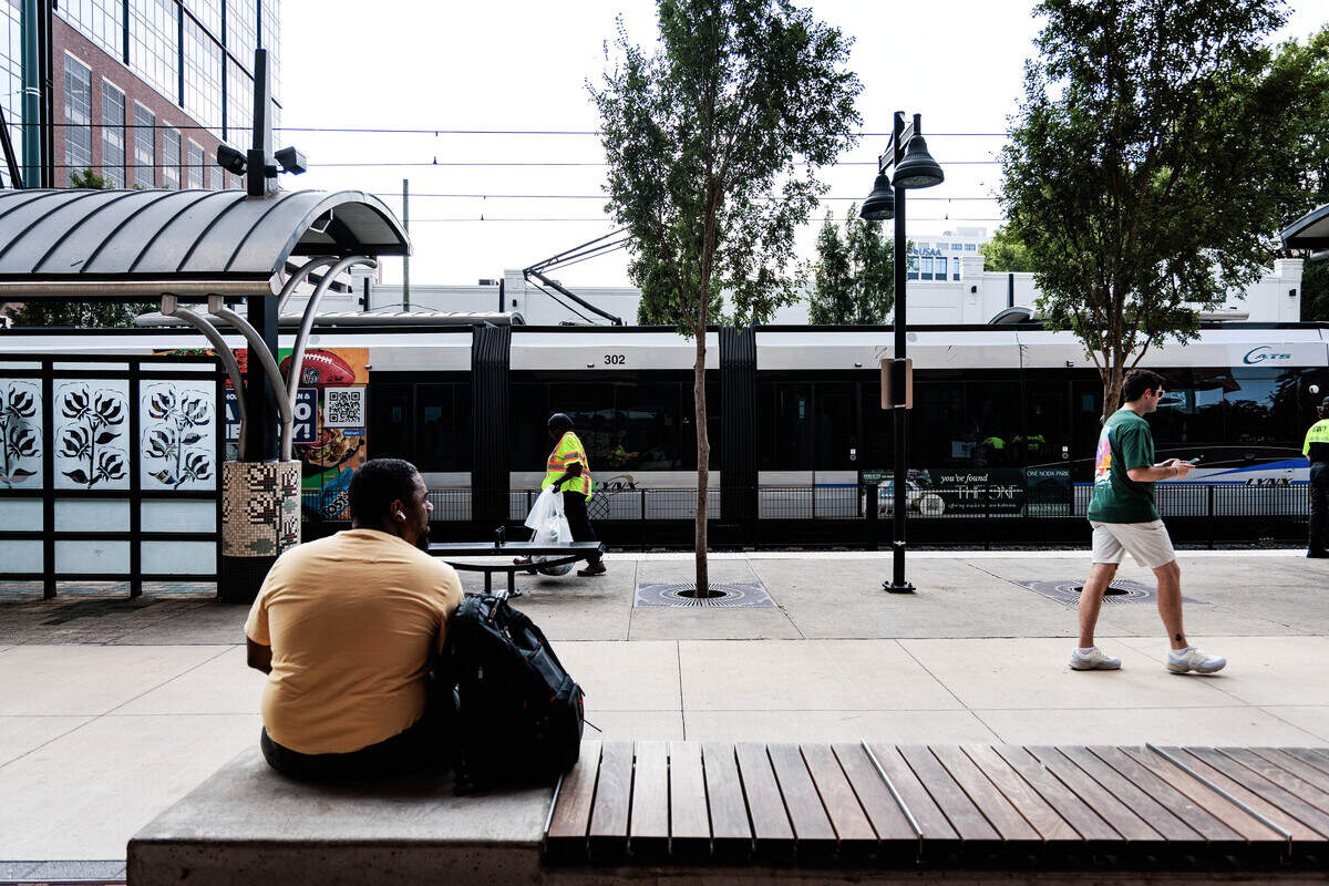 People wait at the East/West Blvd Blue Line stop in South End on Tuesday, June 30, 2026.