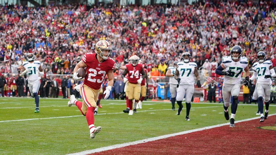 San Francisco 49ers running back Christian McCaffrey (23) scores a touchdown against the Seattle Seahawks in a playoff win Saturday. The Carolina Panthers traded McCaffrey to the 49ers in October for four draft picks.