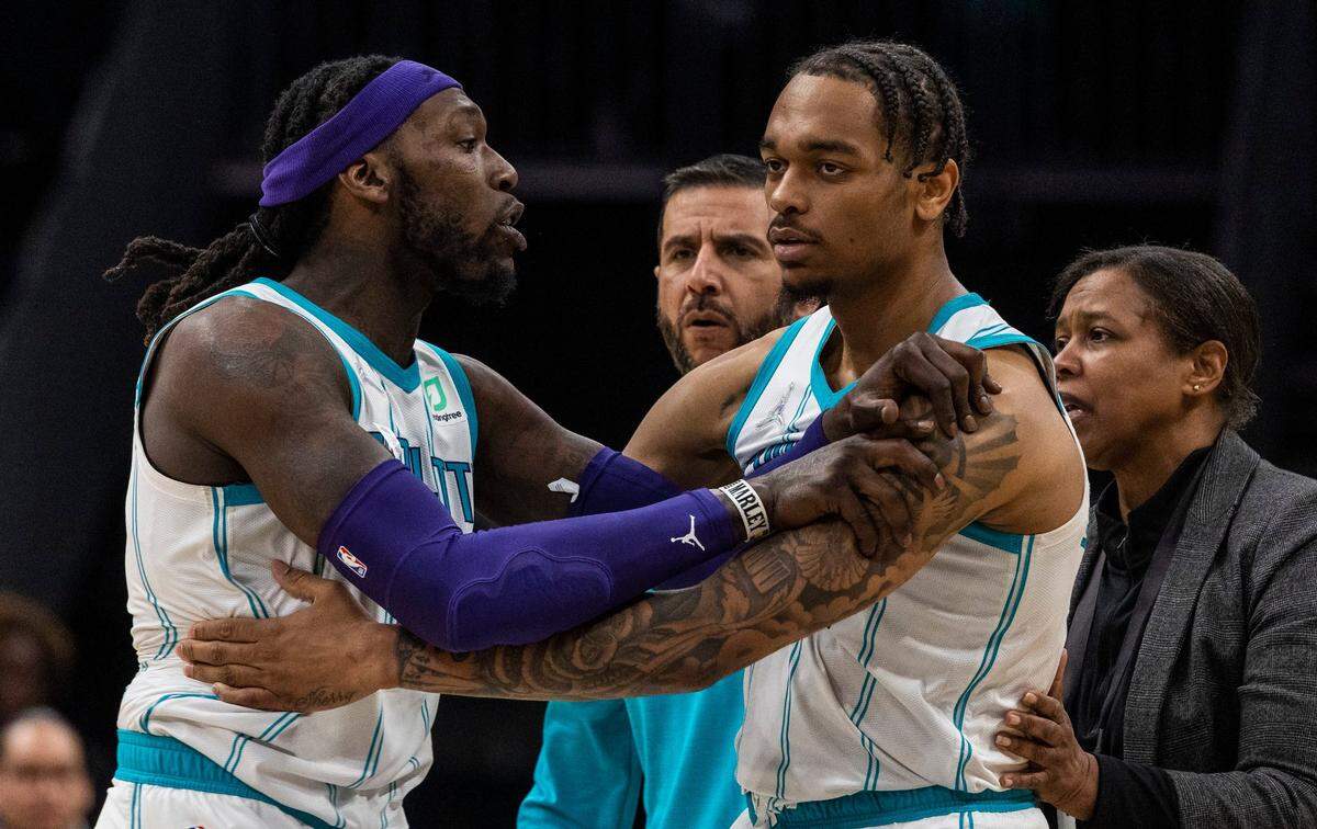 The Hornets’ Montrezl Harrell, left, is held back by teammate PJ Washington after a play that resulted in technical fouls for both teams during the game at Spectrum Center on Monday, March 28, 2022 in Charlotte, NC. After review, a technical foul was given to Denver’s Aaron Gordon and two technical fouls were given to Harrell, who was then ejected from the game. Charlotte lost, 113-109.