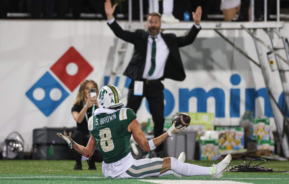 Charlotte wide receiver Sean Brown, center, shrugs in the end zone after scoring a touchdown during the game against Gardner-Webb at Jerry Richardson Stadium in Charlotte, NC on Saturday, September 14, 2024.