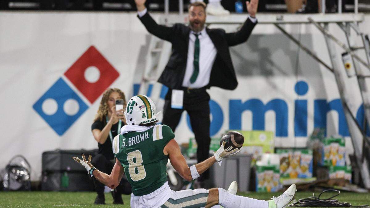 Charlotte wide receiver Sean Brown, center, shrugs in the end zone after scoring a touchdown during the game against Gardner-Webb at Jerry Richardson Stadium in Charlotte, NC on Saturday, September 14, 2024.