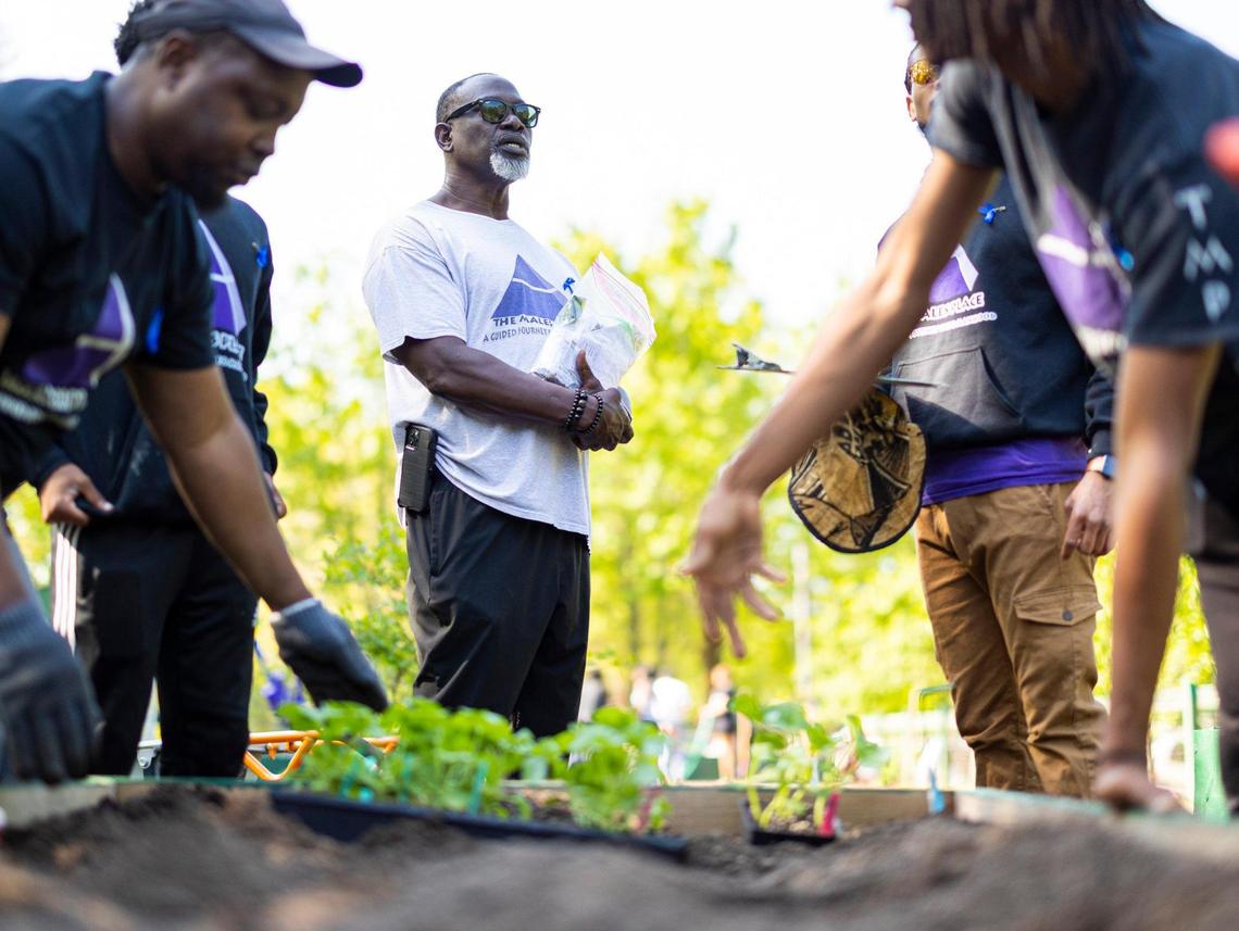 Baba Reggie Singleton talks with the gardeners as they put different vegetable varieties in raised boxes at Fred Alexander Park in late April. The Males Place is a mentoring program for young Black men that teaches self sustainability through gardening as one of the main facets of the program.