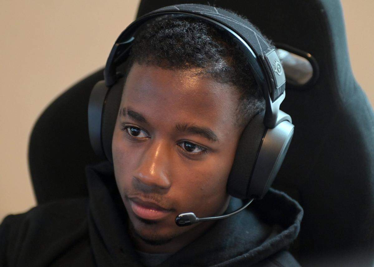 NASCAR driver Rajah Caruth uses his iRacing simulator in his apartment bedroom to compete in a race at Atlanta Motor Speedway on Friday, July 1 2022.