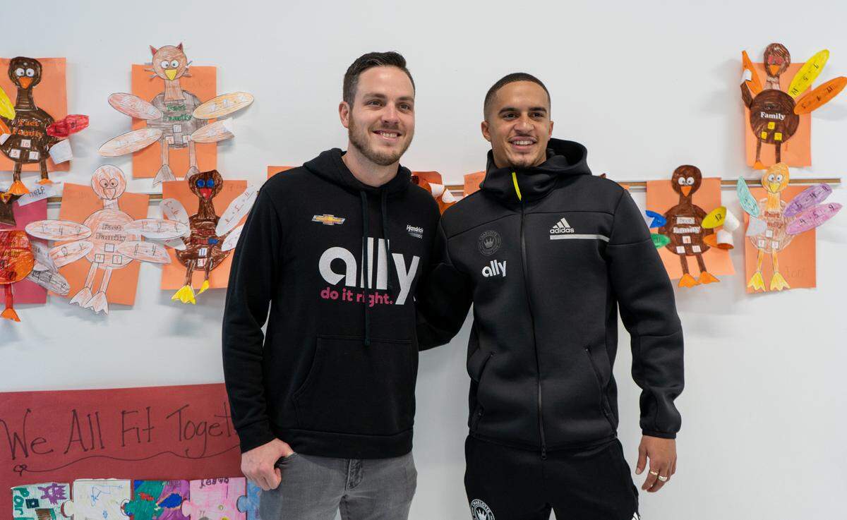 NASCAR Cup Series driver Alex Bowman (left) and Charlotte FC defender Adam Armour spent the afternoon at Lake Norman Charter reading to second-graders about financial literacy.