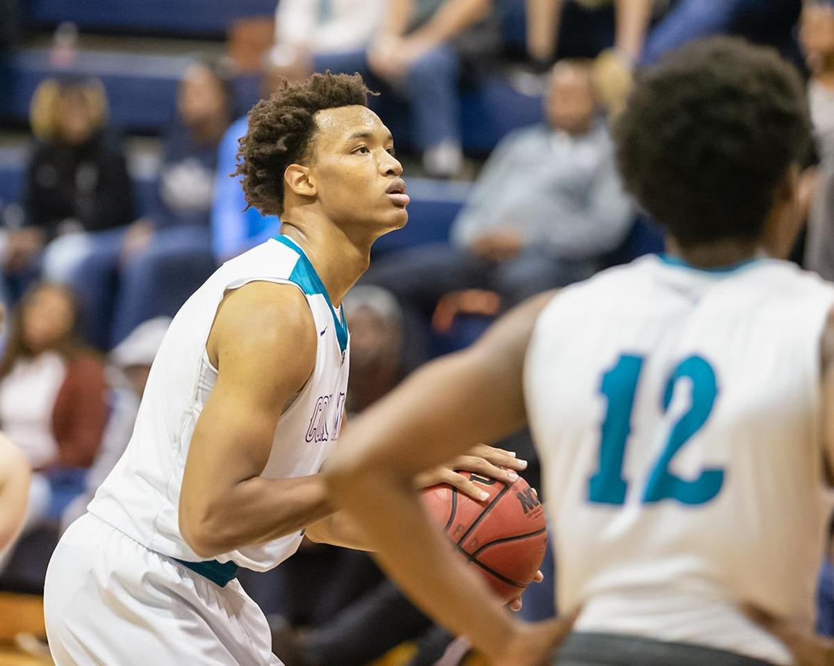 Cox MIll’s Wendell Moore (left) made 13-of-16 free throw attempts in Saturday’s 75-61 win over Greensboro Day at the Crown Town Classic
