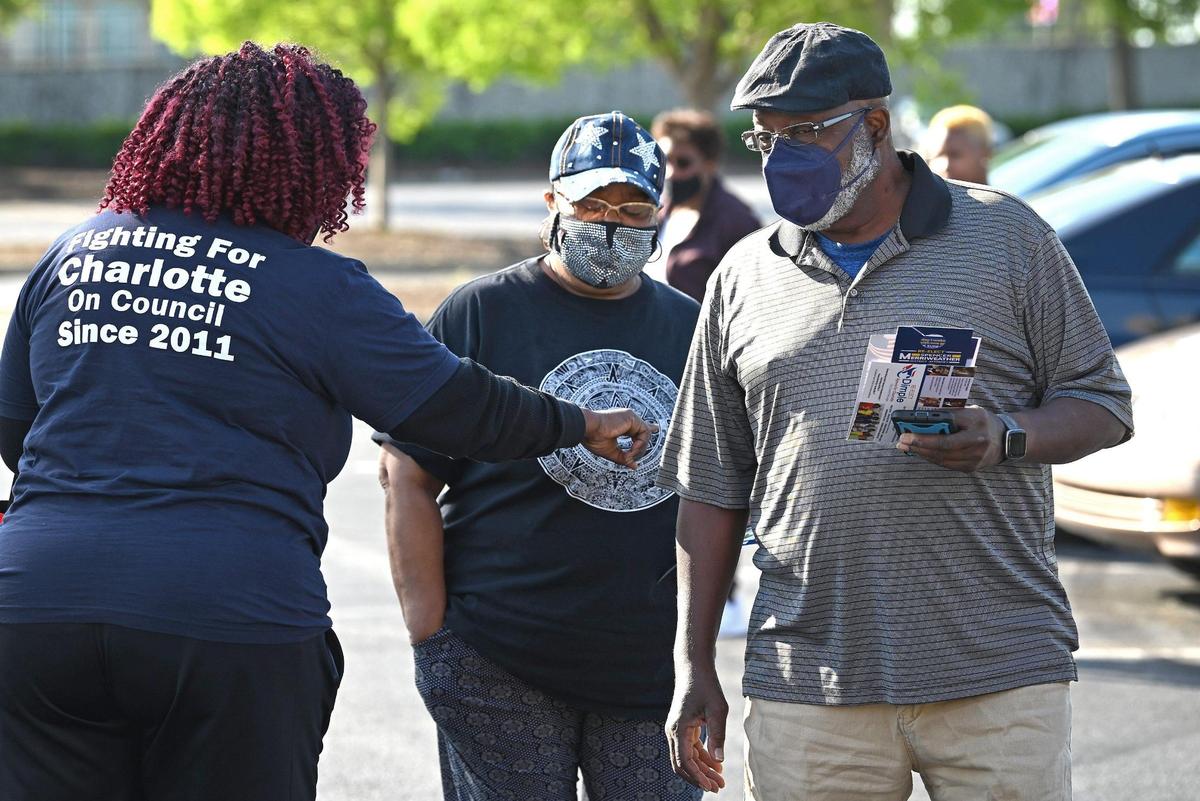 Candidates meet voters as they walk to a voting station in the University City area on Thursday, April 28, 2022. Early voting has started for the NC primaries.