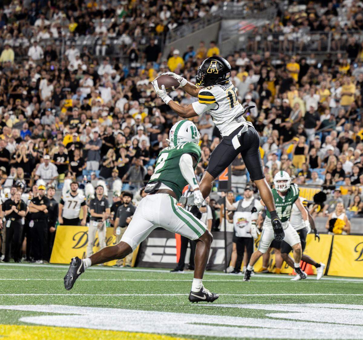 Appalachian State Mountaineers wide receiver Jaden Barnes, right, makes a touchdown over Charlotte 49ers defensive back Treyveon McGee during the Duke's Mayo Classic at the Bank of America Stadium in Charlotte, N.C., on Friday, August 29, 2025.