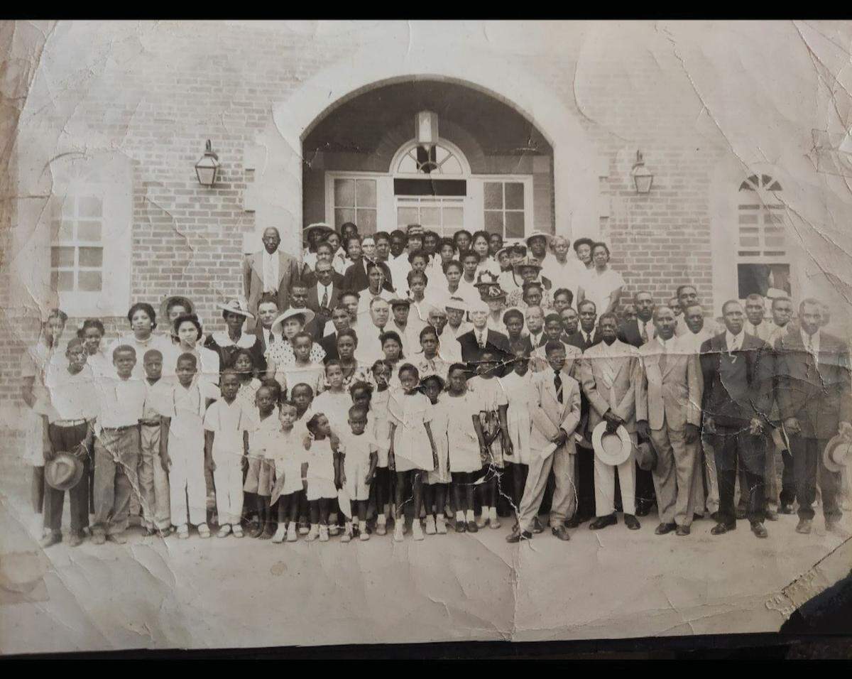 This photo is of the Grier Heights Presbyterian Church Anniversary, 1946. Arthur Grier, a businessman and one of the pioneers of Grier Heights, is in a dark suit near the center of the group.