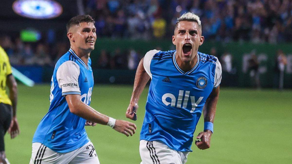 Charlotte FCs Daniel Rios, far right, yells toward the stands after scoring a goal on a penalty kick during the match against Chelsea FC at Bank of America Stadium on Wednesday, July 20, 2022 in Charlotte, NC. The goal by Rios tied the match, 1-1, which resulted in a penalty shootout that Charlotte FC won, 5-3.