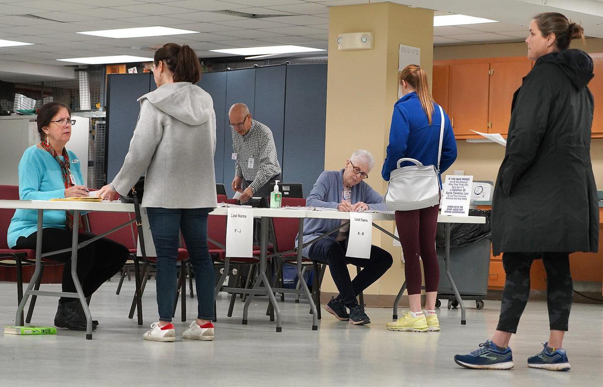 48th Precinct Chief Judge Jane Pasquini, left, election official Rick Gaskins, center and judge Susan Byrd, right, work with voters prior to their voting at Providence United Methodist Church on Tuesday, March 3, 2020.