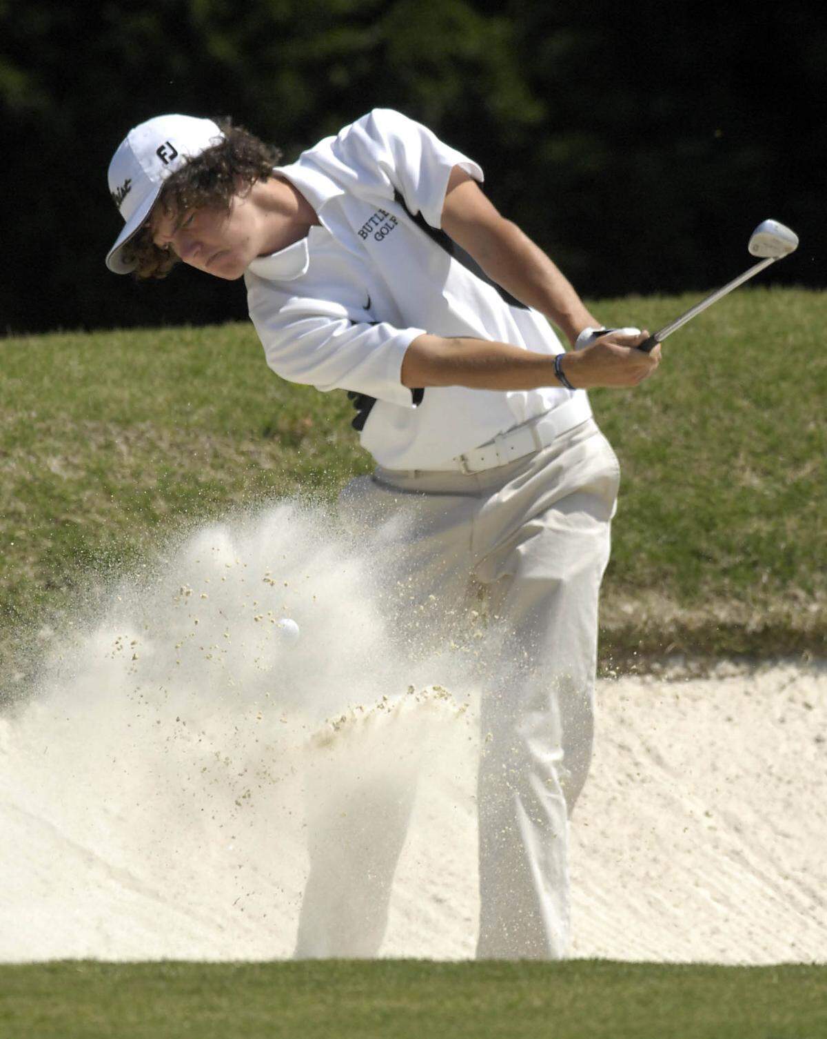 In this photo from May 2007, then-Butler High School student Daniel Meggs chips out of a bunker along the 8th green at at Providence Country Club during the Southwestern 4A high school golf tournament.