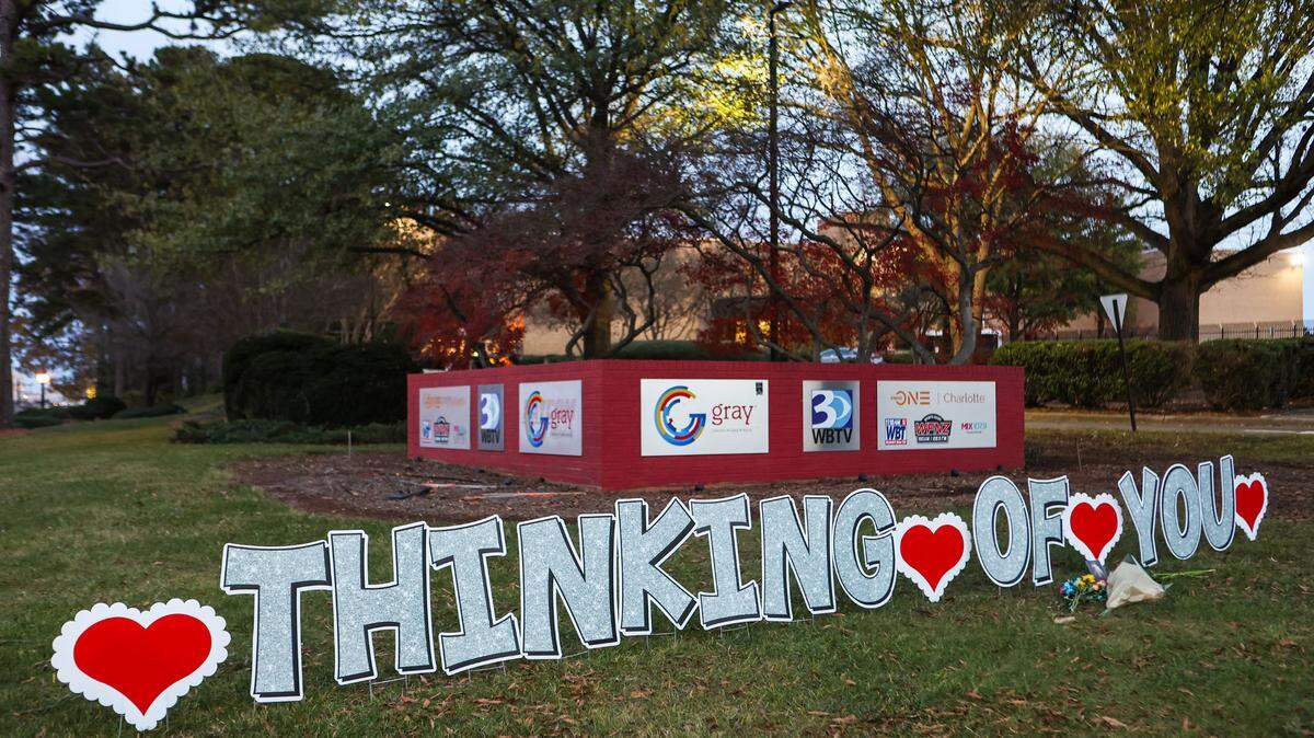 A sign on the lawn in front of the WBTV’s station extends condolences after two of its employees died in a helicopter crash along southbound Interstate 77 earlier this week.