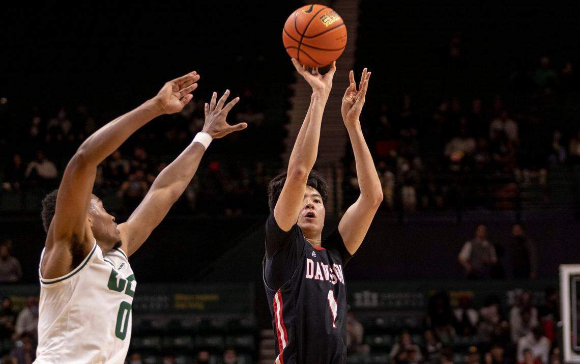 DavidsonÕs Hyunjung Lee, (1) takes a shot against CharlotteÕs Clyde Trapp Jr. during a season matchup at the Halton Arena on Tuesday, November 30, 2021.