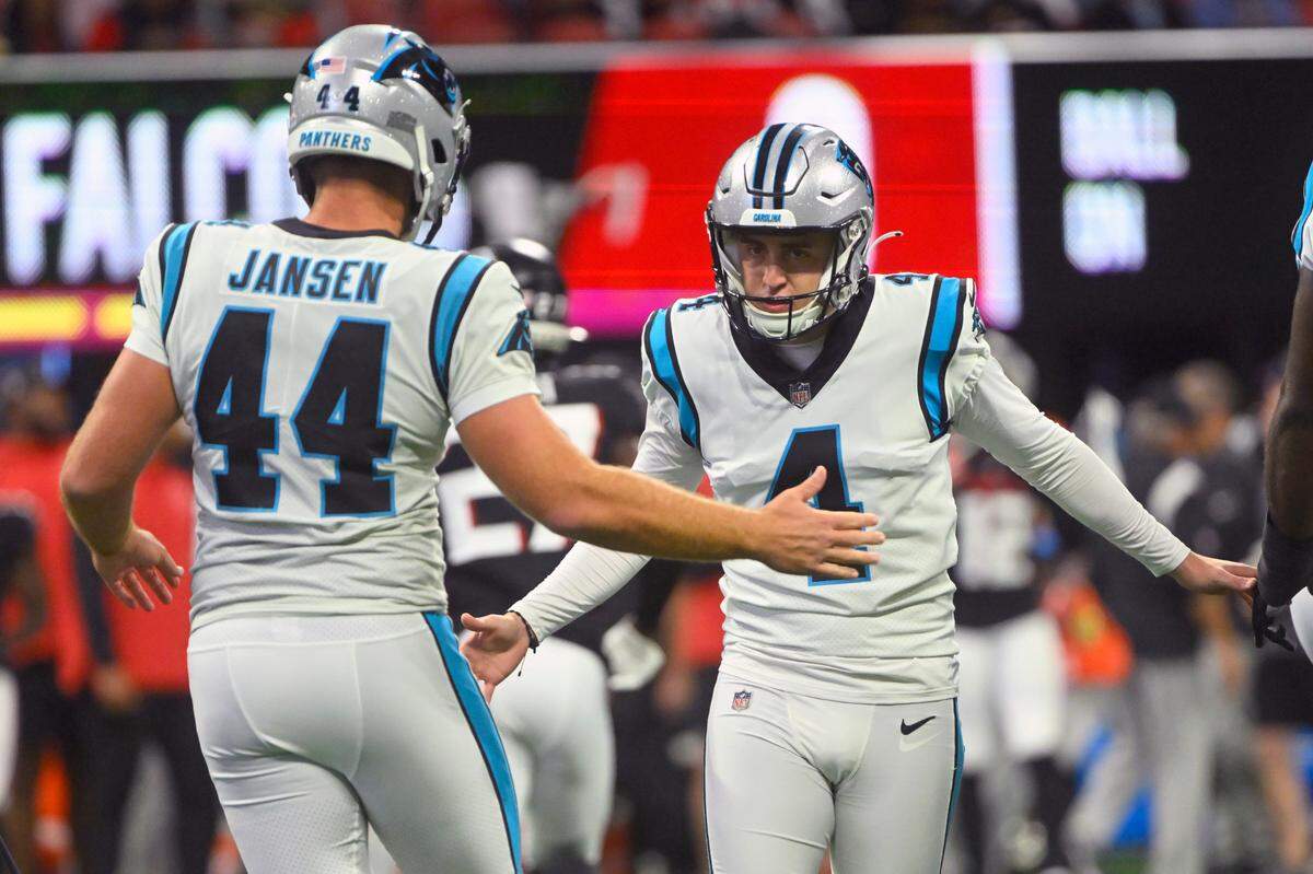Carolina Panthers place kicker Eddy Pineiro (4) is congratulated by JJ Jansen (44) after making a 37-yard field goal during the first half of an NFL football game against the Atlanta Falcons Sunday, Oct. 30, 2022, in Atlanta. (AP Photo/John Amis)