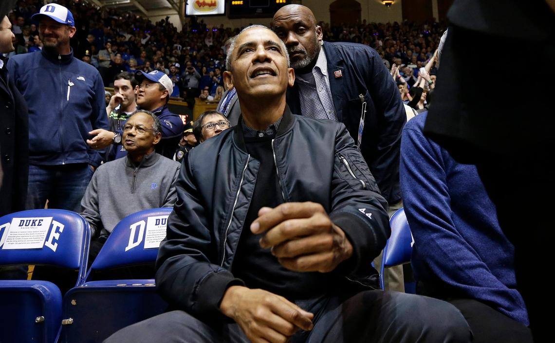 Former President Barack Obama joins fans during an NCAA college basketball game between Duke and North Carolina in Durham, N.C., Wednesday, Feb. 20, 2019. (AP Photo/Gerry Broome)