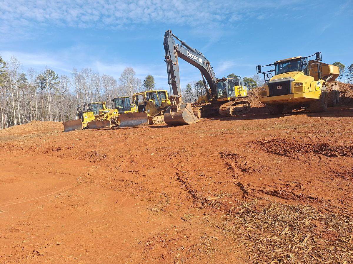Construction vehicles await their next assignment at an east-west traffic-reliever connector road under construction at U.S. 21 and Deerwood Lane on Monday, Feb. 3, 2025.