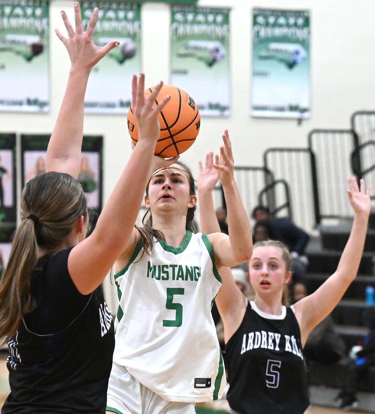 Myers Park’s Laura Lassiter, center, releases a shot between Ardrey Kell defenders Bryson McCoy, left and Molly Burns, right, during action on Friday, January 5, 2024 at Myers Park High.