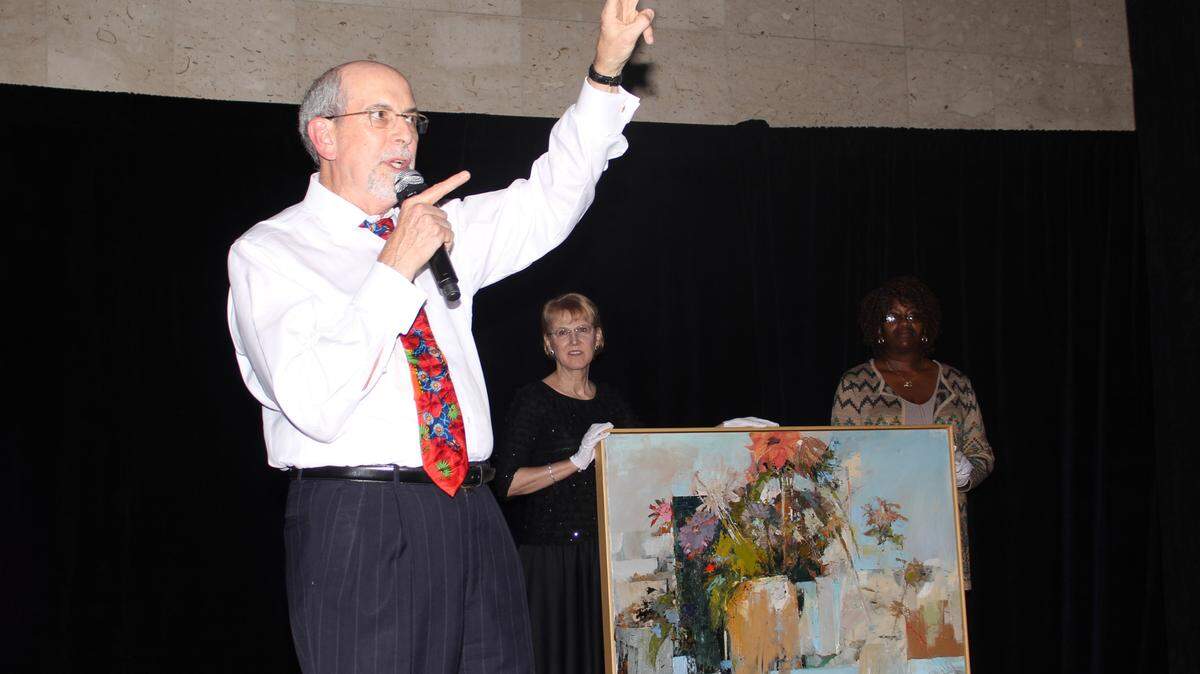 Ernest Perry auctioneering at a Feb. 11, 2017, event for Art With Heart. Perry was the auctioneer at hundreds of charity events, his family said.