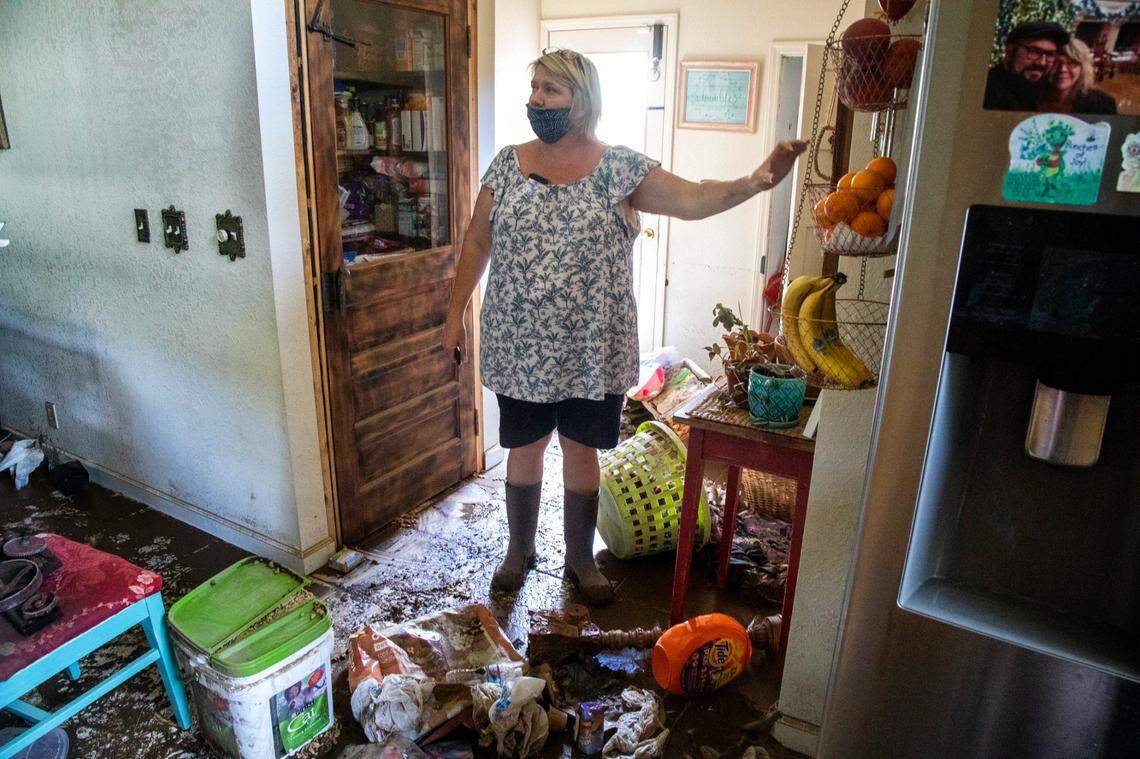 Donella Pressley looks over the flood damage to her home Thursday, Aug. 19, 2021 in Bethel after remnants from Tropical Storm Fred caused flooding in parts of Western North Carolina Tuesday. Search and rescue teams continue to search the area as 20 people are missing and 2 people were found dead.