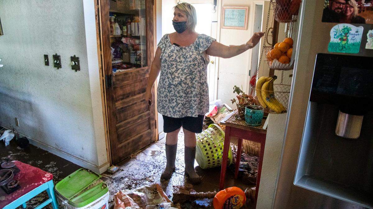 Donella Pressley looks over the flood damage to her home Aug. 19, 2021 in Bethel after remnants from Tropical Storm Fred caused flooding in parts of Western North Carolina. Six people died in Haywood County and the community of Cruso was devastated, with rebuilding likely to take years.
